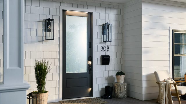 The Masonite M-Pwr Smart Door installed as the front door of a modern home. Fully powered, the door includes built-in LED lights and a built-in Ring Video Doorbell that requires no battery.