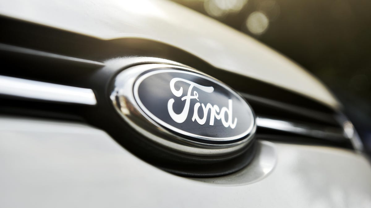 Close-up of a Ford logo on the front of a vehicle.