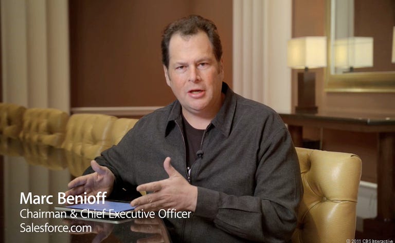 Salesforce.com CEO Marc Benioff with an iPad 2, has a different opinion on the iPad's use in the enterprise than Dell exec Andy Lark.