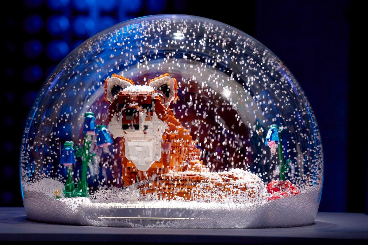 A Lego fox in a snow globe