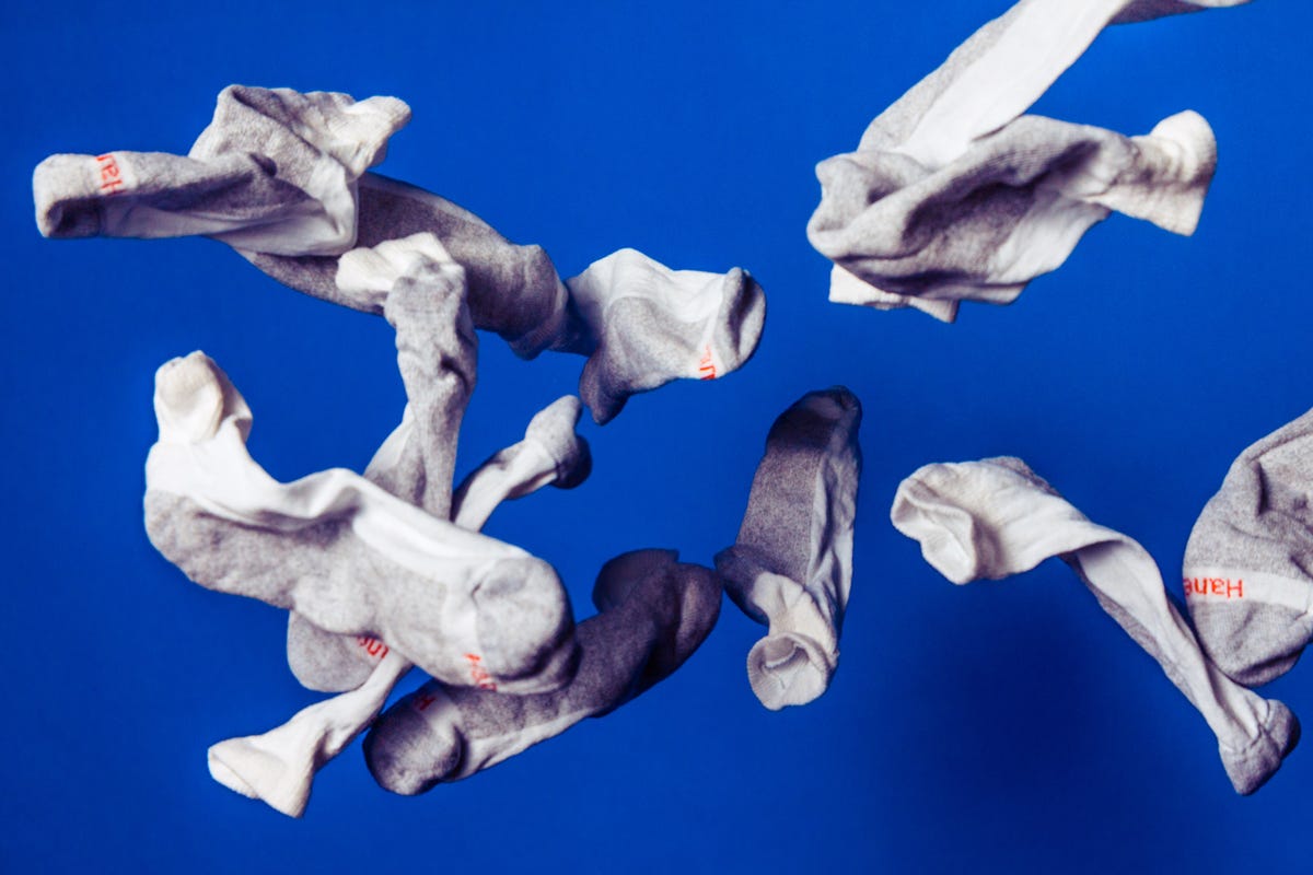 an array of flying white socks against a blue background