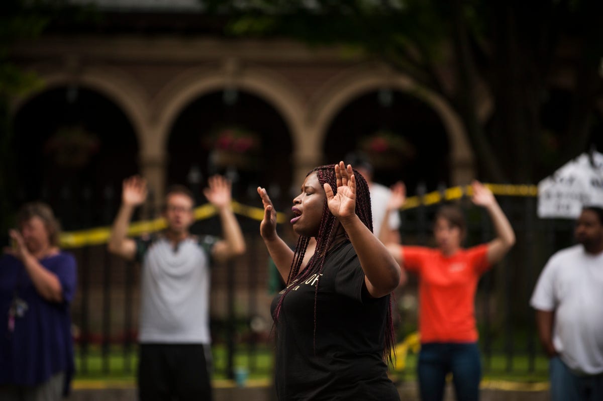 Minneapolis NAACP President Nekima Levy-Pounds leads a chant of "Hands up, don't shoot" outside the Minnesota governor's mansion one day after Philando Castile's death.