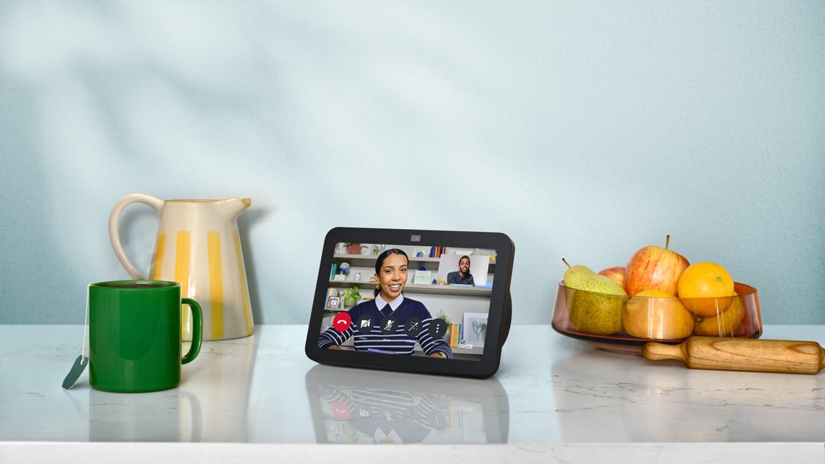 Amazon Echo Show 8 on a countertop with pitcher, mug, bowl of fruit
