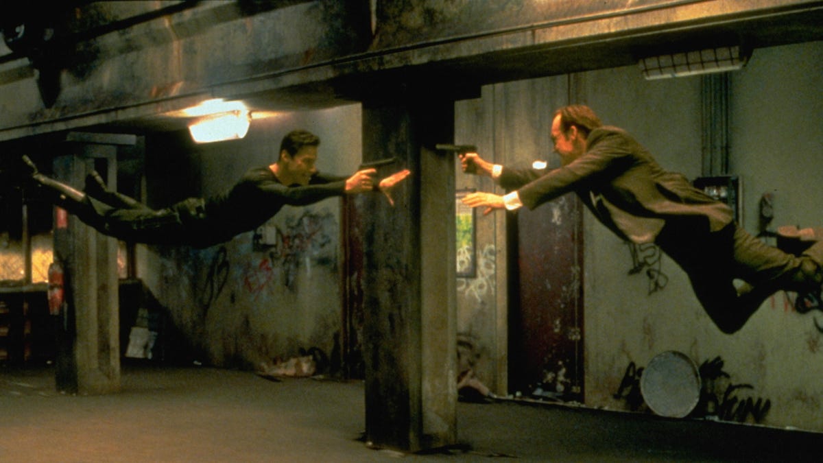 Keanu Reeves and Hugo Weaving face each other in a scene from Andy and Larry Wachowski's 1999 movie The Matrix. In this scene, Neo (Reeves) fights the computerized Agent Smith (Weaving). (Photo by Siemoneit/Sygma via Getty Images)