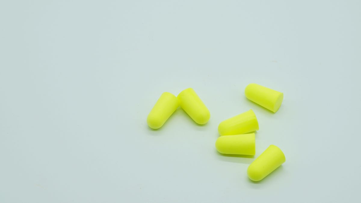 A handful of neon yellow earplugs