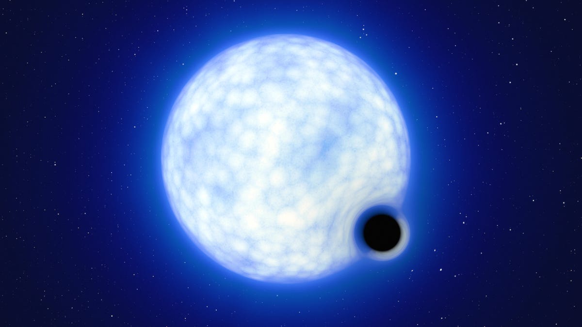 a computer-generated illustration of a giant blue-white star in the void of space. At its bottom right corner is an artists illustration of a black hole -- a small, black circle reflecting no light.