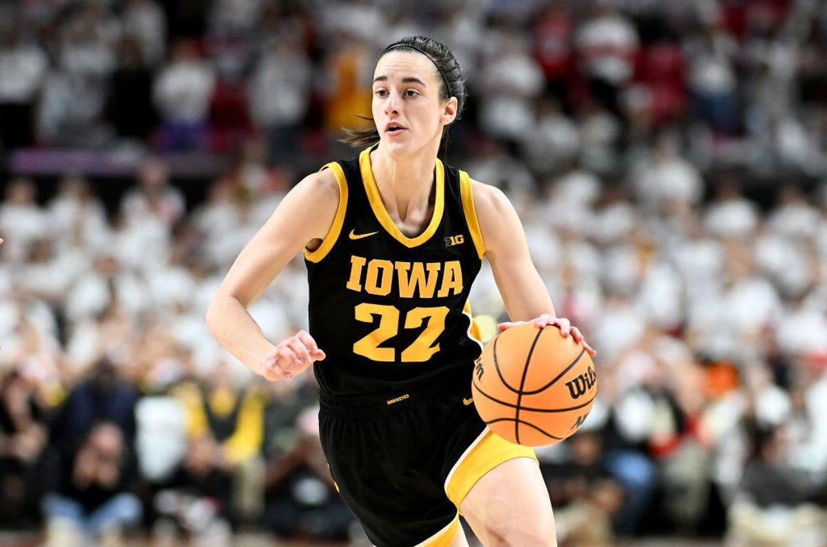 Caitlin Clark of Iowa dribbles the ball and looks up court
