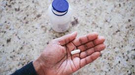 Woman holding magnesium supplement