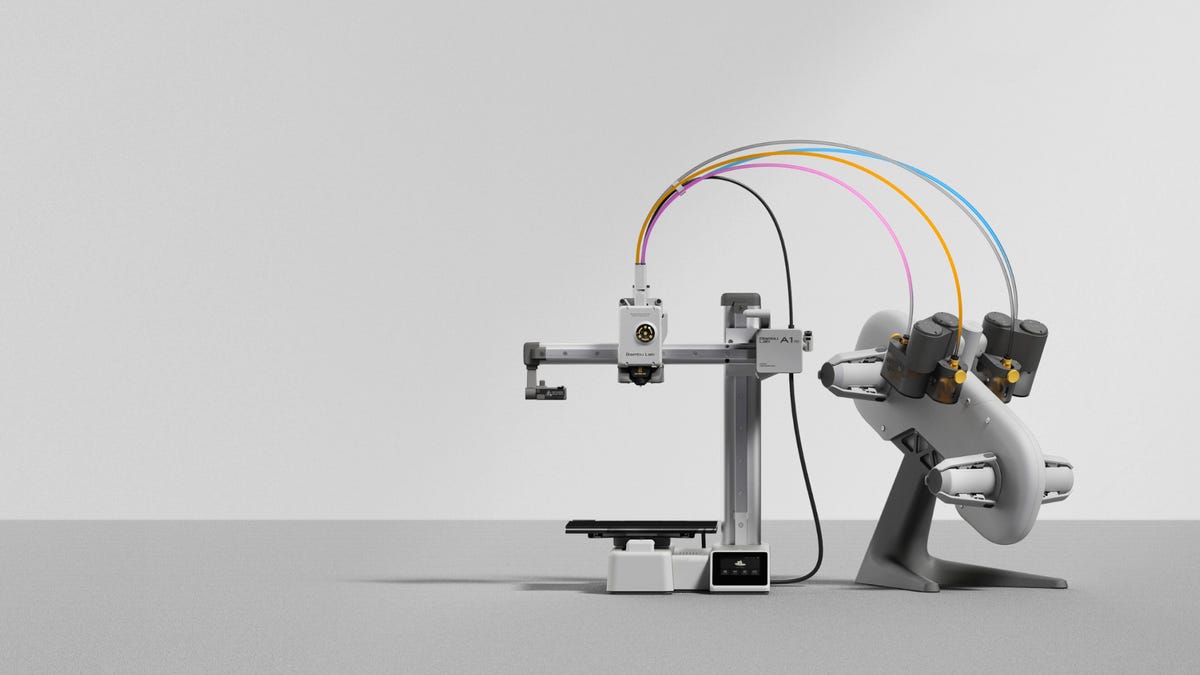 A small gray 3d printer with an external machine for adding color