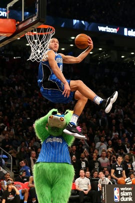 Basketball player Aaron Gordon gets airborne for a slam dunk.