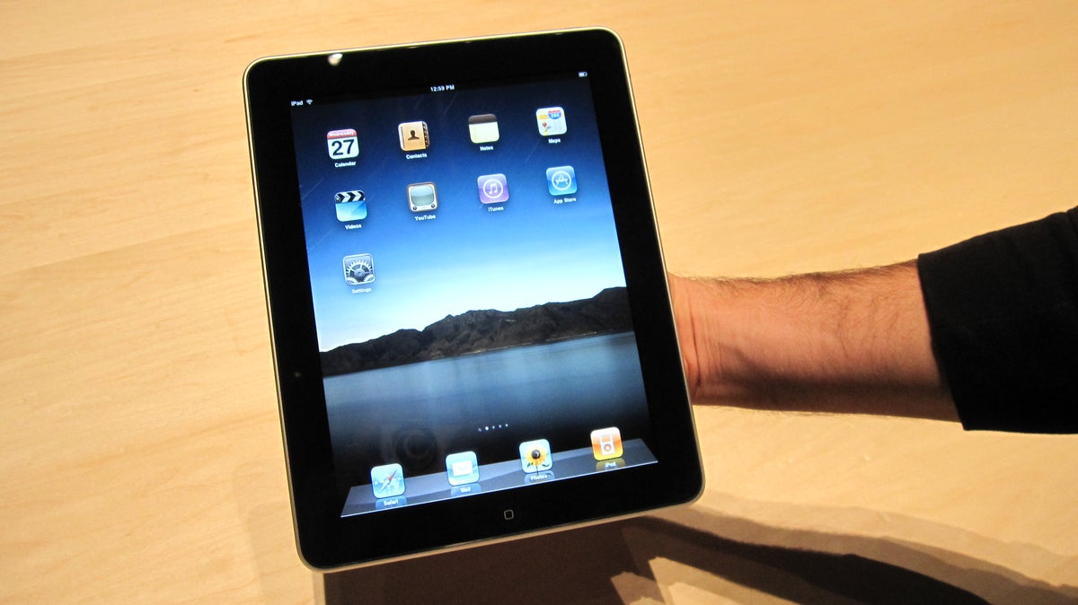 Photo of hand holding Apple iPad.