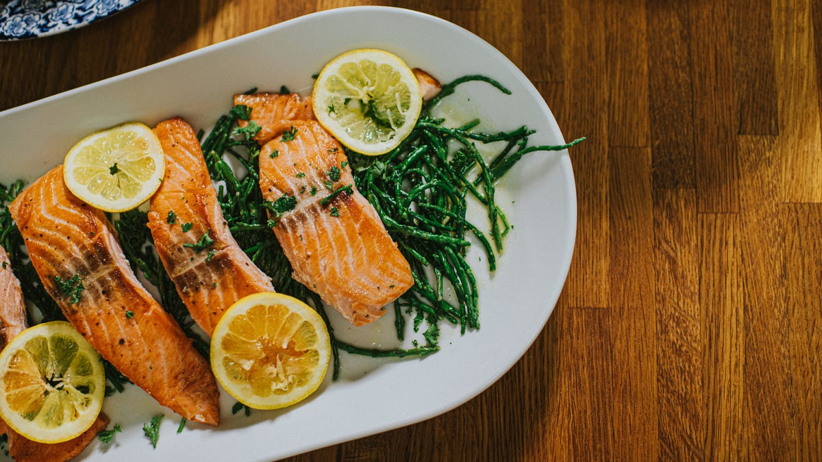 A plate of salmon, lemon and greens for high blood pressure
