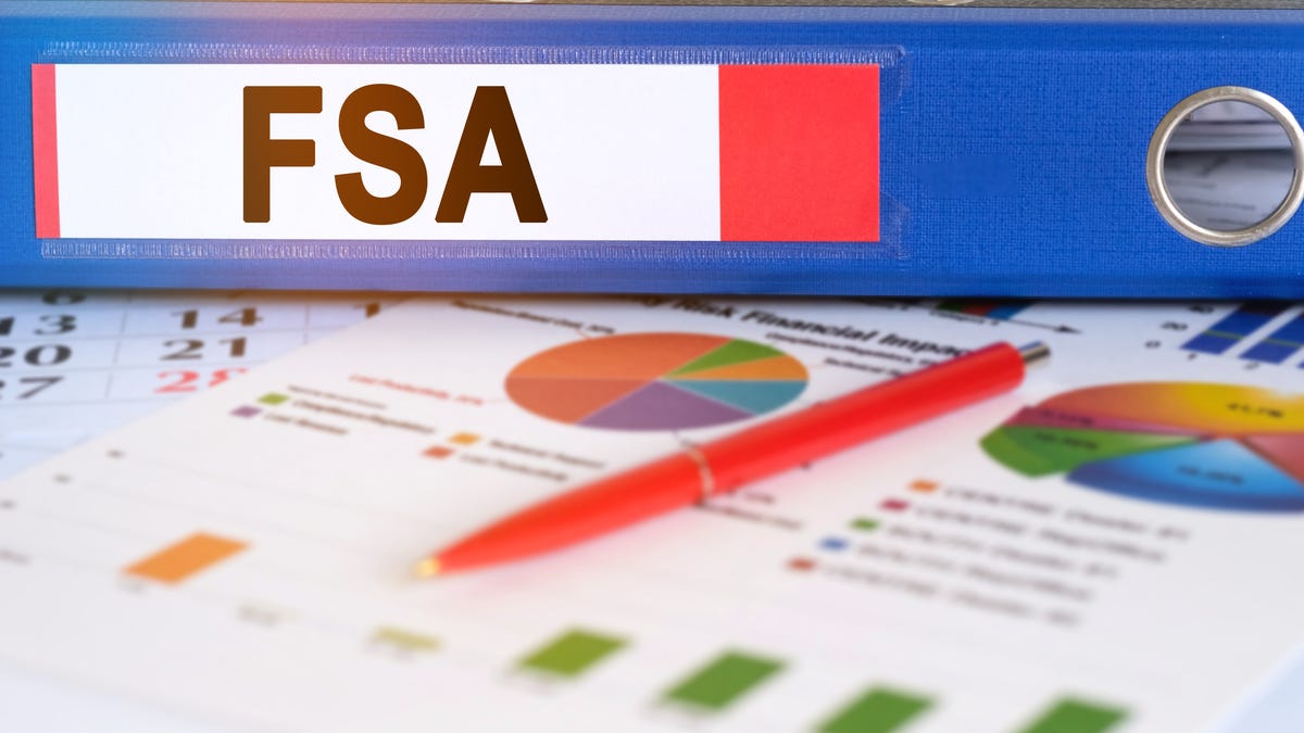 A photo of an FSA sticker on a level on top of papers showing charts and graphs
