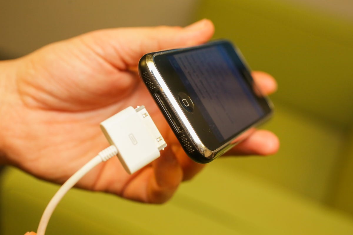 The original iPhone and charging cable with its 30-pin connector