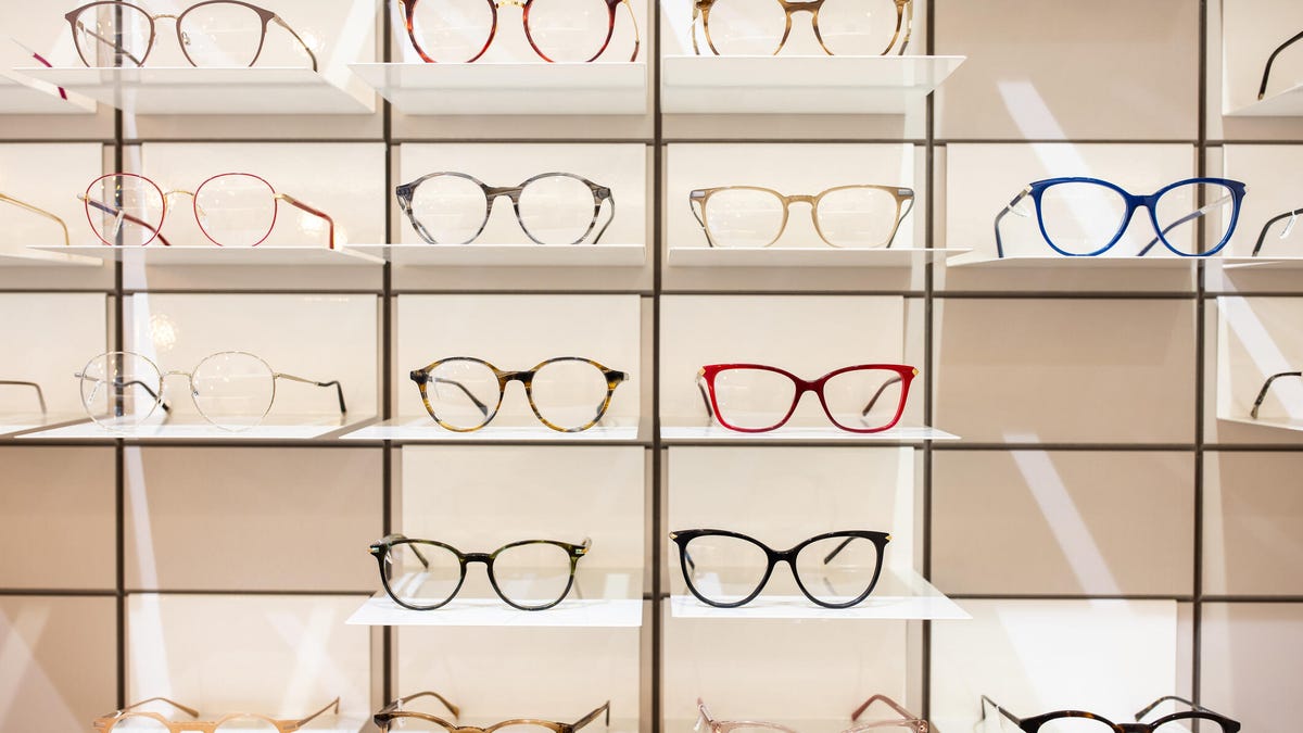 Retail wall with shelf full of different eyeglasses