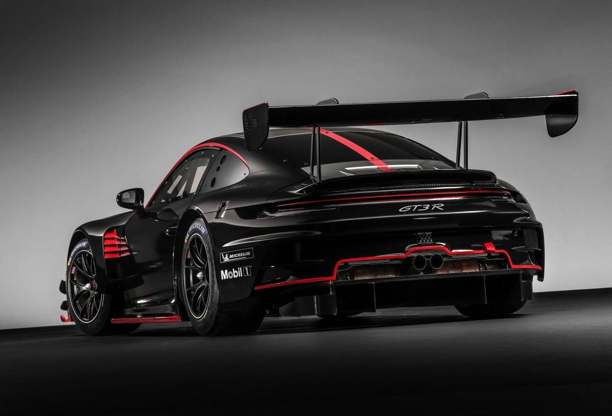 The 2022 Porsche 911 GT3 R, looking moody in black with red trim and a giant wing hanging off the back.