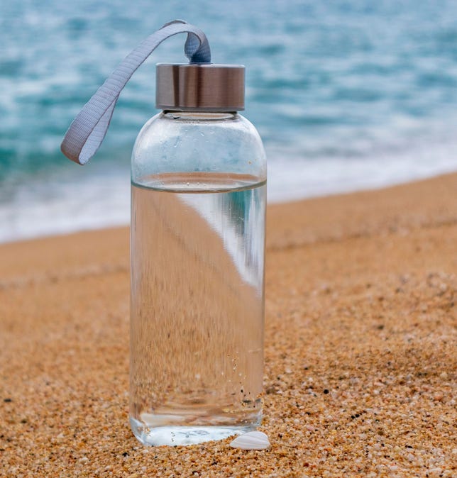 Bottle filled with water on the beach