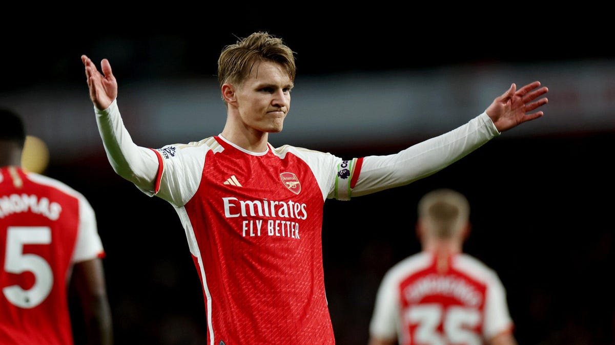 Martin Odegaard of Arsenal celebrating with arms aloft.