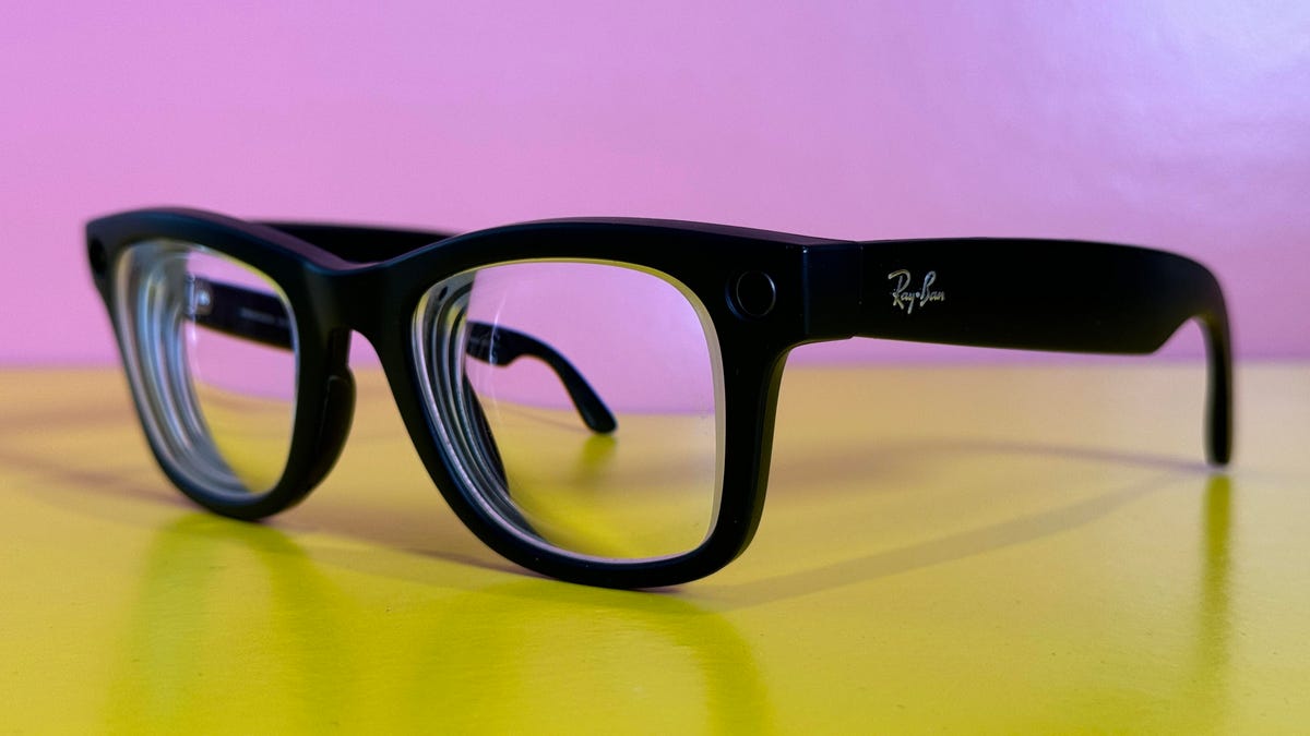 A black pair of Meta Ray-Ban glasses on a yellow table
