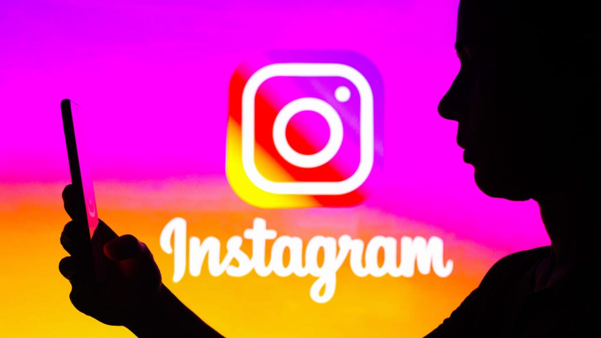 Instagram logo with person on smartphone