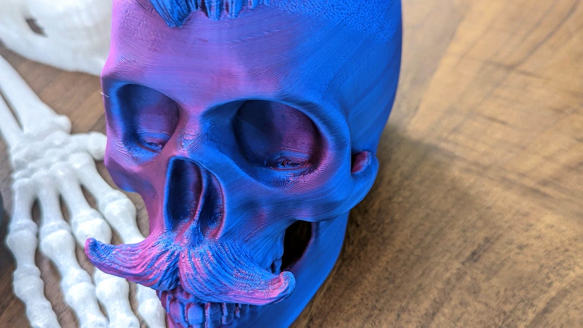 Purple and blue skull with slightly damaged eyes