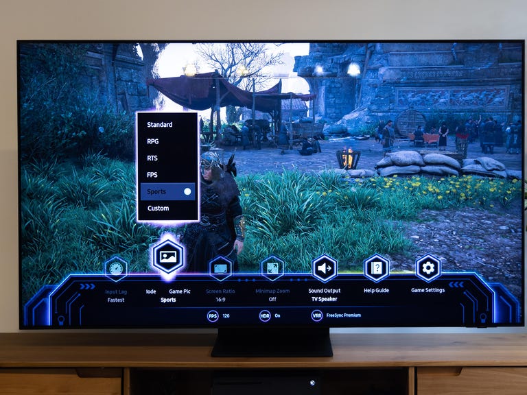 The Samsung QN90B QLED TV has a settings screen with different game modes.