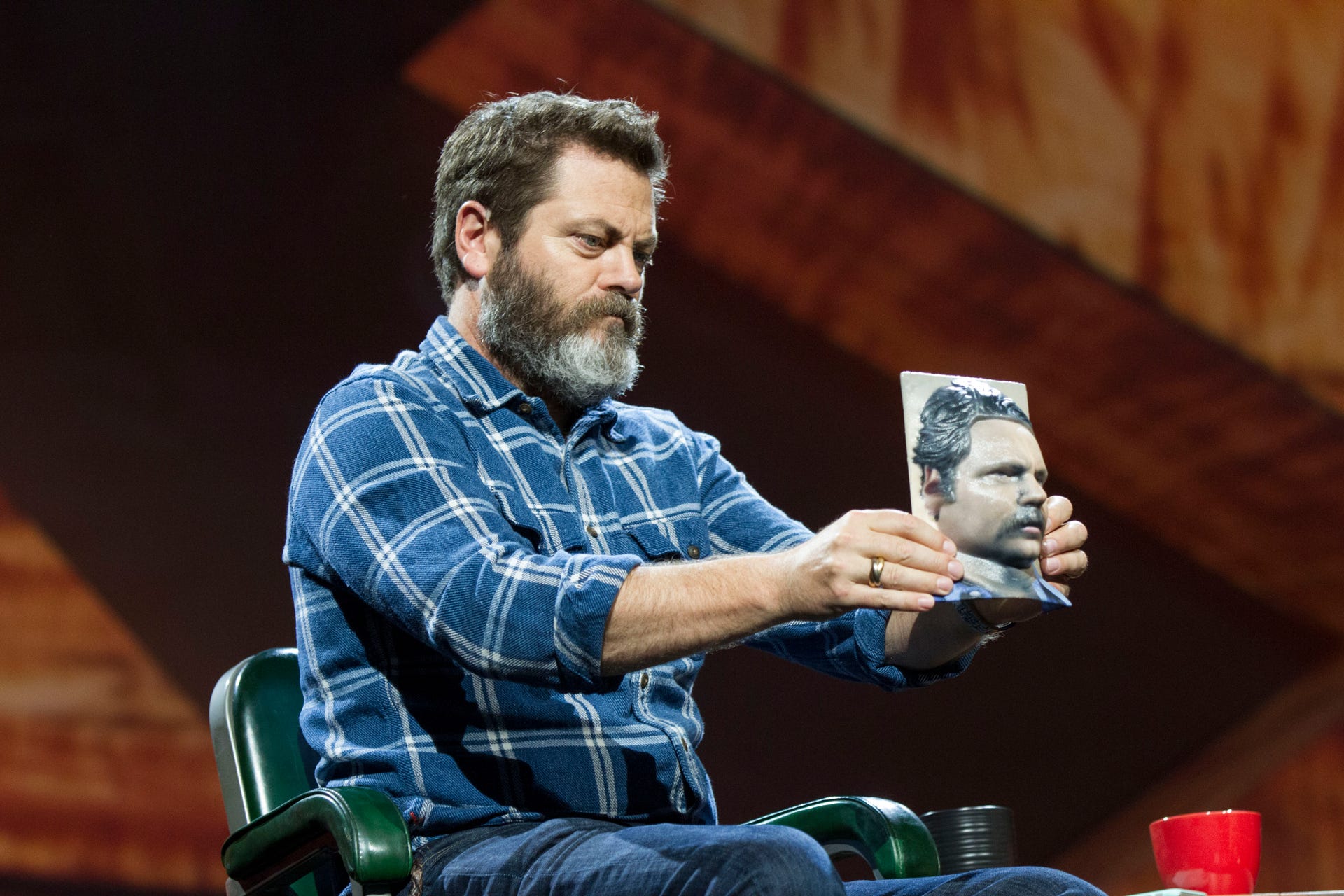At Adobe's Max conference, Parks and Recreation actor Nick Offerman holds a 3D-printed model of his head reconstructed from a photo.