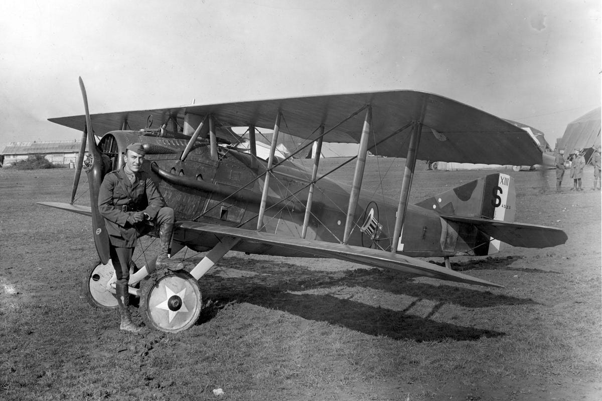 Eddie Rickenbacker strikes a jaunty pose with his Spad S.XIII biplane
