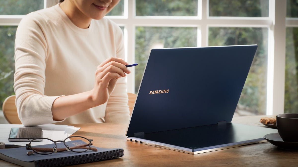 A woman using the Samsung Galaxy Flex2 Alpha laptop. 