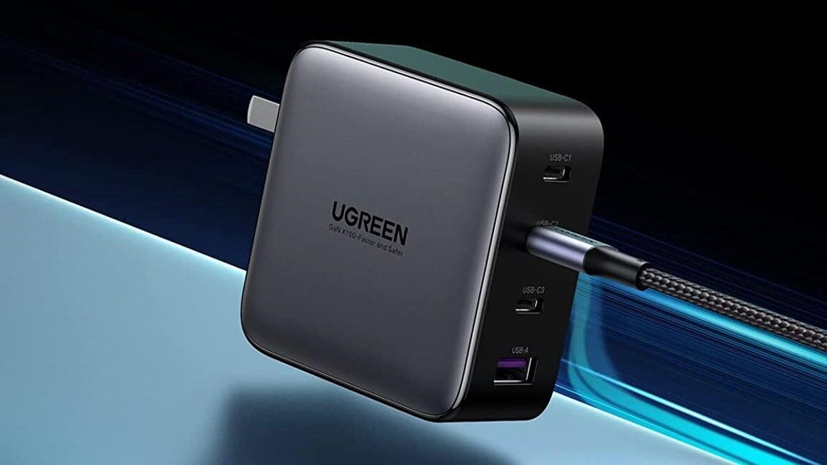 A four-port UGreen wall charger against a blue background.