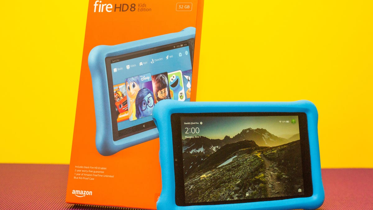 A Fire HD 8 Kids edition tablet with its orange box against a yellow background.