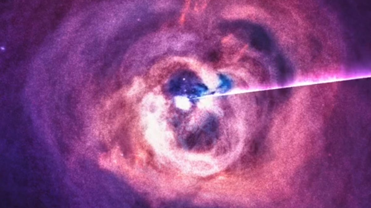 purple, pink and orange gas swirls around a bright white circle from the black hole in the Perseus constellation