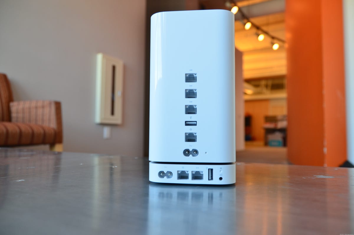 The new AirPort Extreme Base Station has the same footprint as the AirPort Express (bottom), but is much taller. Note the AirPlay audio port on the AirPort Express that the AirPort Extreme doesn't have.