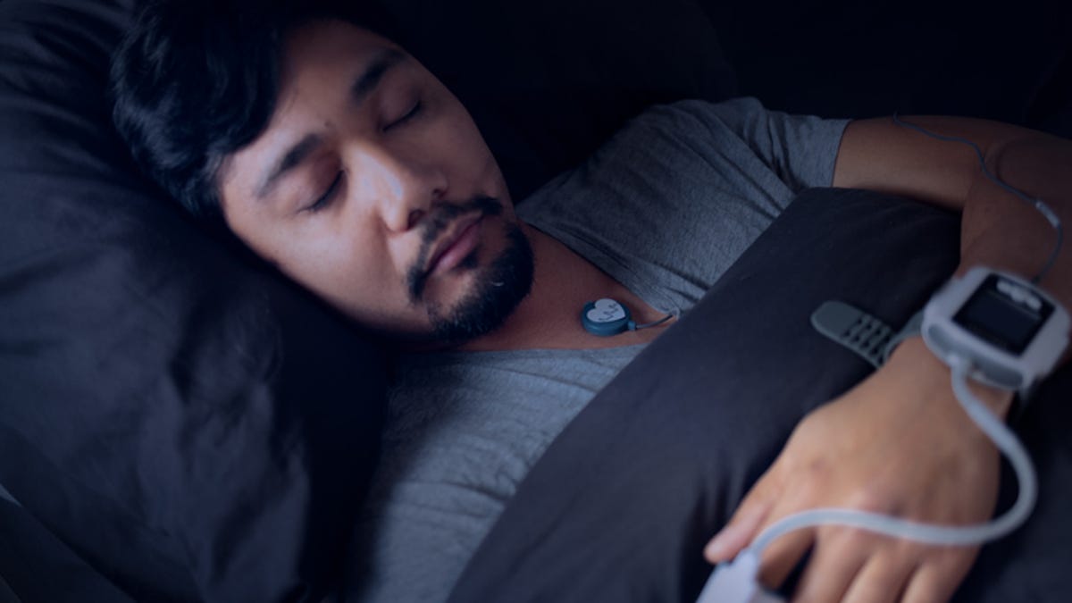 Man wearing an at-home sleep apnea test while sleeping.