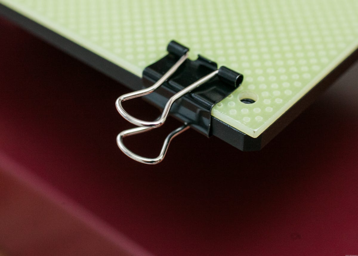 Office-supply binder clips hold the printing surface to the build platform.