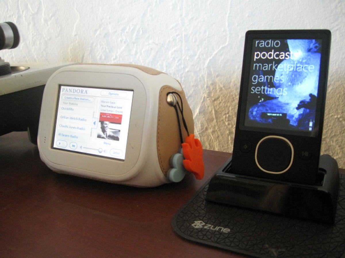 Photo of Chumby next to Zune 80 MP3 player of table.