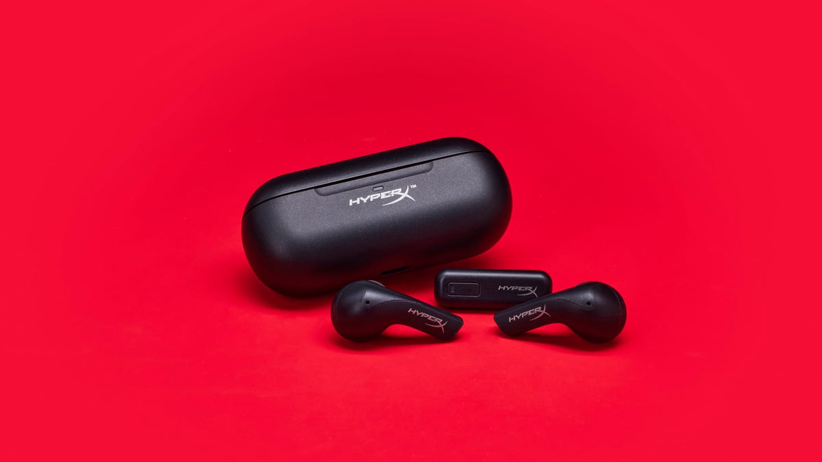 HyperX Cloud Mix Buds with their USB-C wireless receiver and storage charging case on a red background