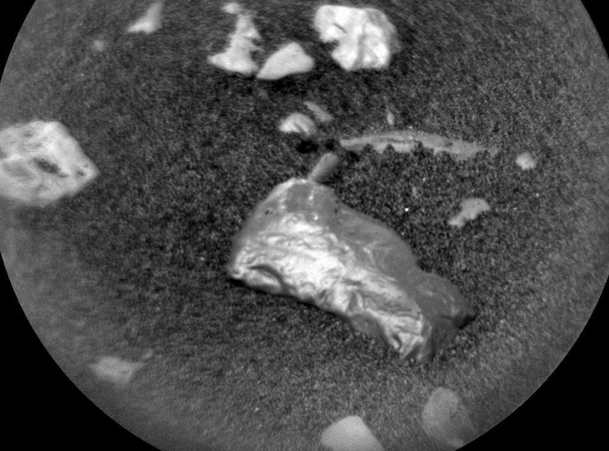 Shiny, tiny Martian rock that is likely a meteorite seen in super closeup of Martian surface.