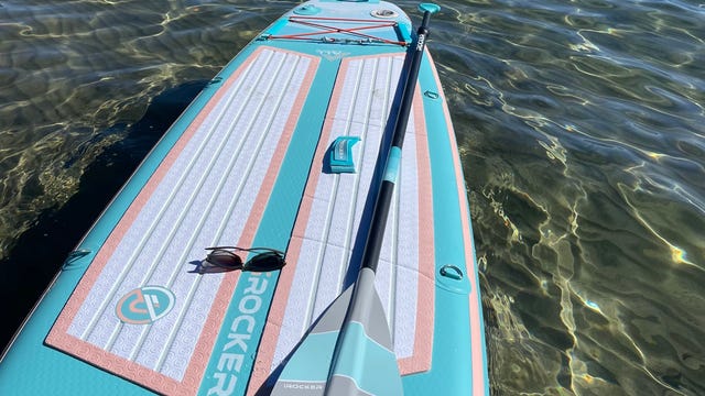 IRocker Paddle Board with its paddle floating in Lake Tahoe