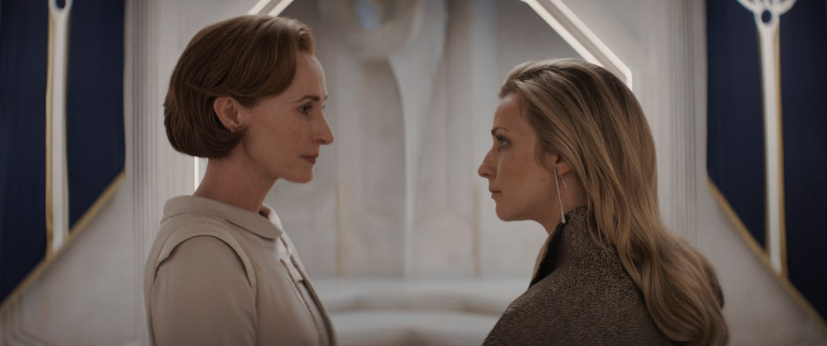 Mon Mothma and Vel Sartha talk in front of a white door in Andor