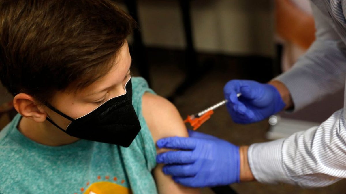 A child receives a COVID vaccine