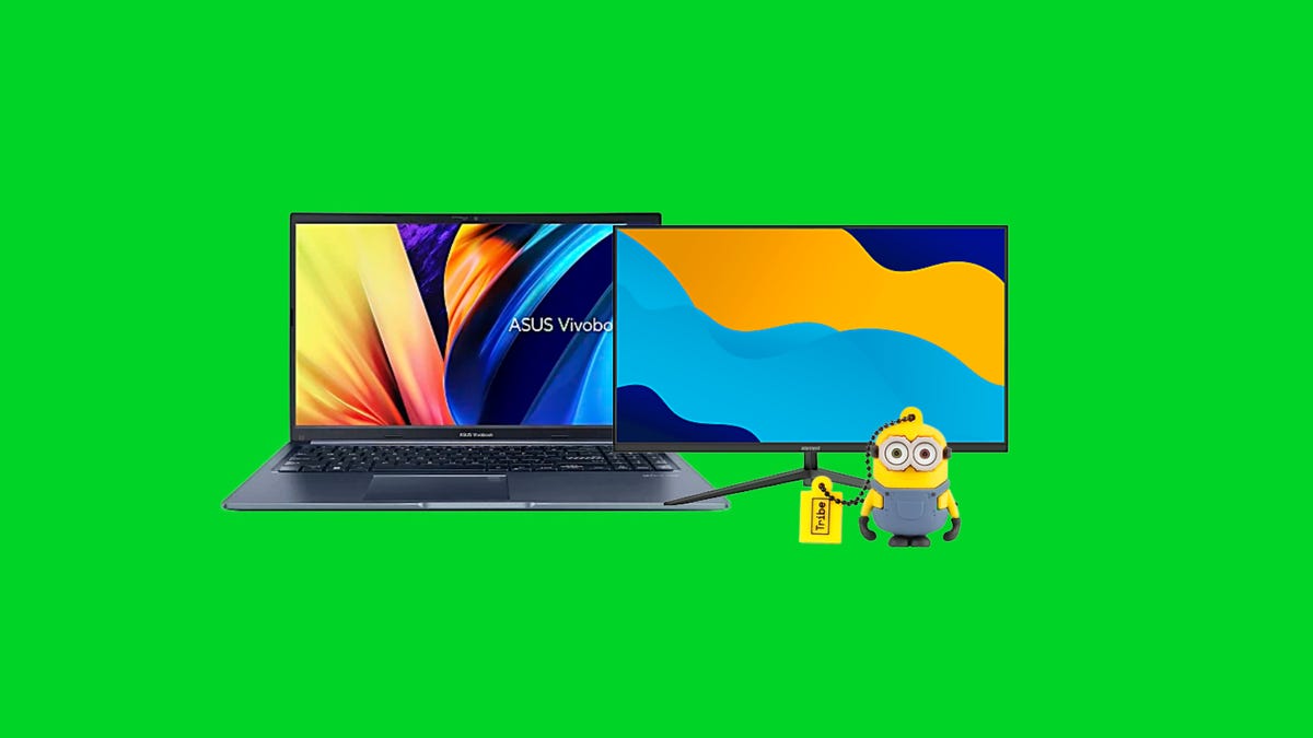 A laptop, monitor and Minion USB flash drive on green background