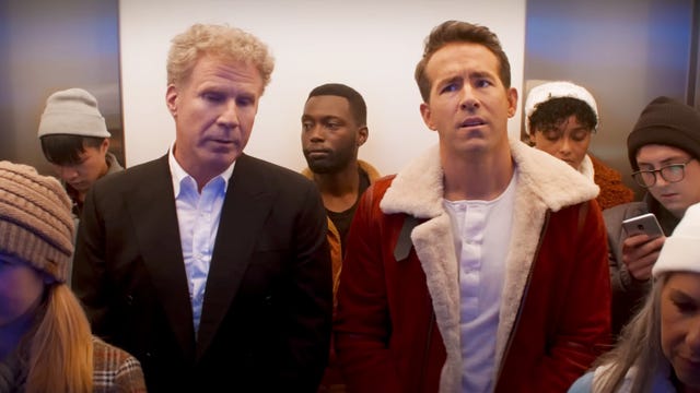 Will Ferrell and Ryan Reynolds -- who's wearing a Santa suit -- standing in a lift