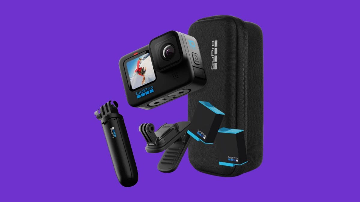 A GoPro Hero 10 camera, and a grip, mount, batteries and other accessories against a purple background.