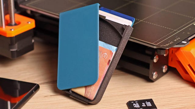 3D printed wallet with a printer behind it