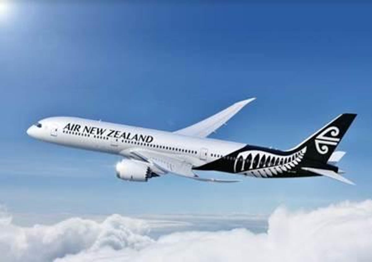 A Boeing 787 in Air New Zealand livery in the sky with clouds.