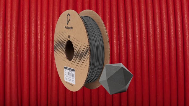 Black filament on a cardboard spool with a red background