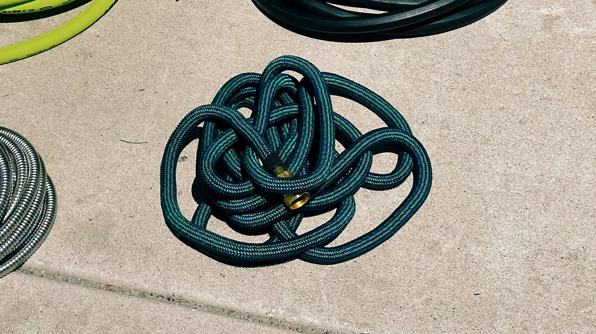 showing the WeGuard expandable garden hose coiled up