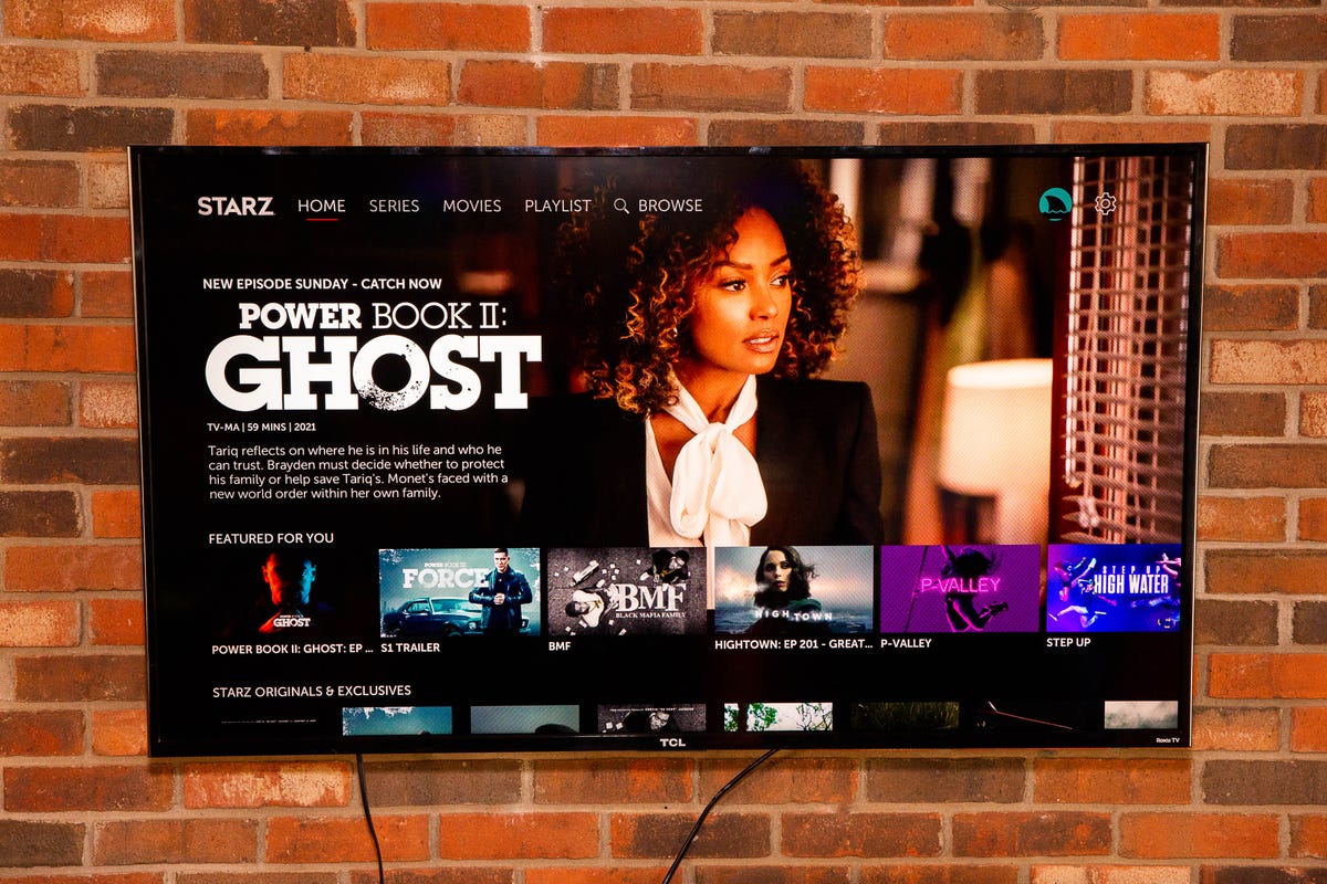Starz's Power content displayed on a TV mounted on a brick wall