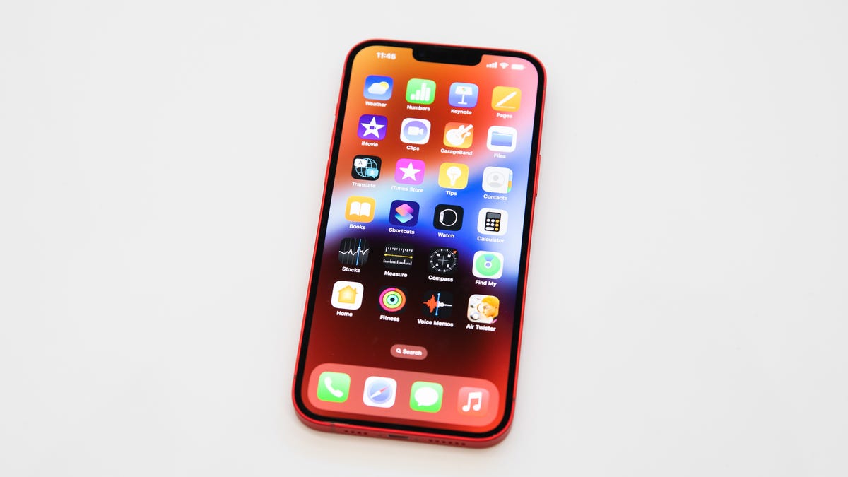 iPhone 14 with a grid of app icons on the screen